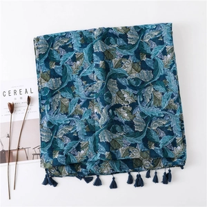 Detailed view of paisley feather print cotton linen scarf with elegant fringe tassels