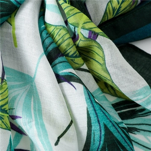 Lightweight white beach shawl scarf with green tropical leaf prints and fringe trim