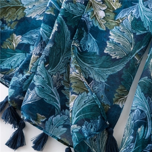 Detail of bohemian cashew leaf print scarf with navy blue fringe and soft linen texture