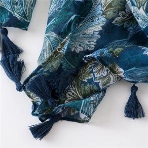 Macro detail of navy cashew leaf print on cotton-linen scarf with thick tassels