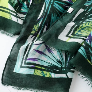 Detail of tropical palm leaf print on lightweight viscose fabric with frayed edges