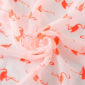 Detail of flamingo print on lightweight pink cotton linen scarf with soft fabric folds