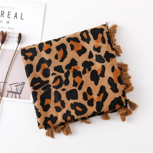 Close-up of leopard print scarf with soft fringe edges and classic brown leopard patterns
