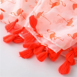 Detail of pink cotton linen scarf with orange flamingo print and tassel fringe