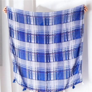 Blue and white plaid scarf with corner tassels made of breathable cotton linen fabric