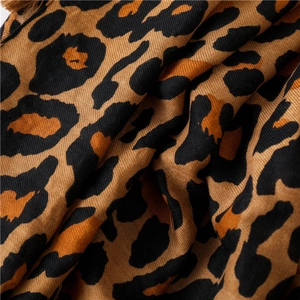 Macro detail of classic leopard print cotton linen scarf with twill weave and fringes