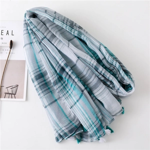Detail of teal and white plaid cotton linen scarf with soft handmade fringe tassels