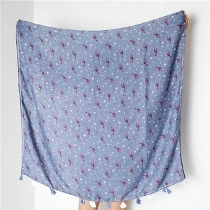 Detail of light blue scarf featuring purple deer prints and blue-white fringe tassels