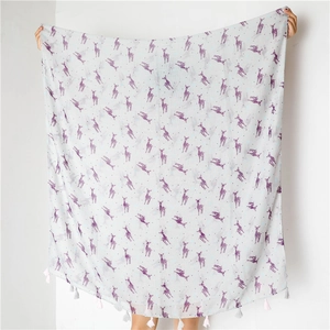 Close-up of lightweight scarf featuring purple deer prints and colorful fringe tassels