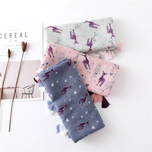 Detail of colorful deer pattern scarves with fringe tassels and minimalist decor