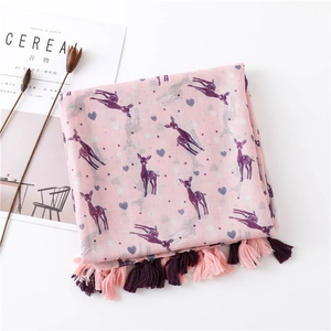 Detail of pink cotton scarf featuring purple deer prints and handmade fringed tassels