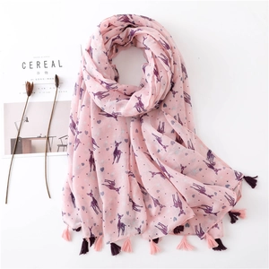 Detail of pink scarf with purple deer patterns, heart motifs and fringed tassel edges