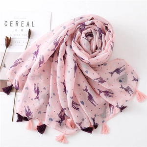 Close-up of pink artistic scarf with deer prints and fringe tassels on a white background