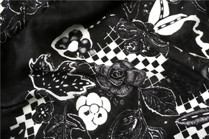 Macro shot of cotton linen scarf with black and white floral prints and checkerboard details