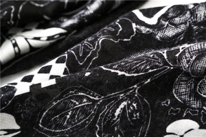 Macro detail of cotton-linen fabric with vintage floral and checkerboard print patterns