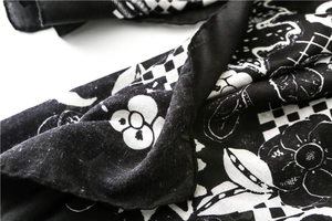 Detail of classic black and white floral print on soft satin cotton scarf with hemmed edges
