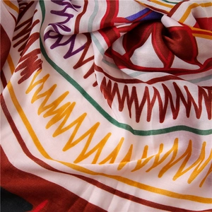 Close-up of vibrant geometric print beach scarf with soft cotton-linen texture and tassels