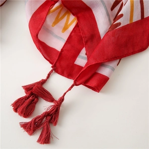 Close-up of red ethnic beach shawl with geometric patterns and handcrafted tassels