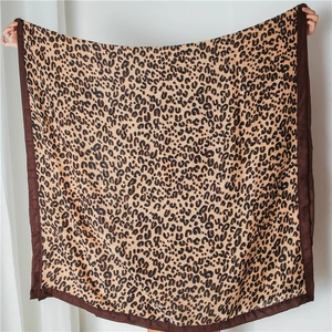 Detailed view of leopard print cotton linen shawl with reinforced stitched edges