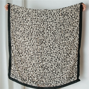Close-up of oversized cotton linen shawl featuring leopard print and thick black edges