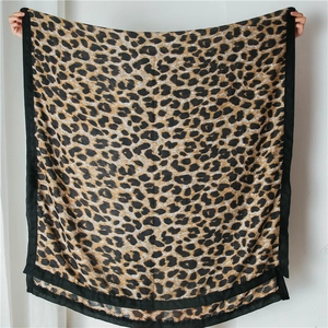 Detail of classic leopard print cotton linen shawl with bold black borders and thick texture