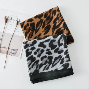Macro view of leopard print cotton scarf with black borders and soft texture