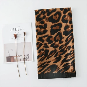 Detail of leopard print shawl with black edges and soft cotton linen texture