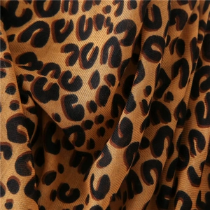 Detailed macro view showing the texture of thick leopard print cotton linen shawl fabric