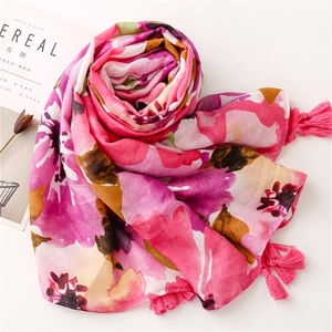 Floral print cotton linen scarf with soft pink flowers and tassel details for beach vacation