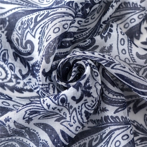 Detail of navy paisley floral print on lightweight white cotton linen shawl fabric