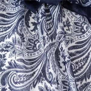 Close-up of navy blue and white paisley print fabric showing detailed linen texture