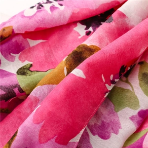 Macro detail of soft cotton-linen scarf showing vibrant floral watercolor print and texture