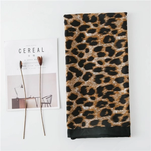 Detail of leopard print cotton linen scarf with black edge and soft texture