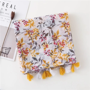 Close-up of lightweight linen-silk scarf featuring yellow leaves and red berry print
