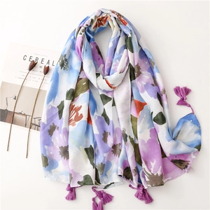 Lightweight floral linen-feel scarf with colorful print and fringe tassels on white background