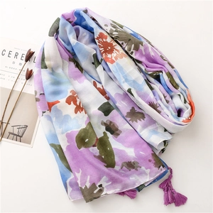 Detailed macro shot of abstract floral pattern scarf with decorative purple tassels