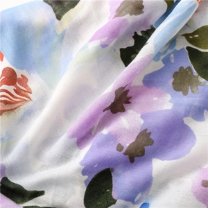 Macro view of herringbone texture and artistic floral print on soft cotton linen scarf