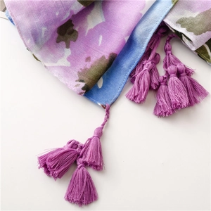 Detail of colorful cotton-linen scarf showing soft texture and purple fringe tassels