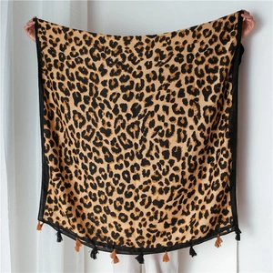 Detail of leopard print scarf featuring soft cotton-linen texture and black fringe tassels