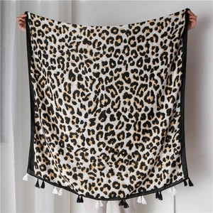 Detail view of leopard print scarf featuring soft cotton-linen feel and stylish fringe trim