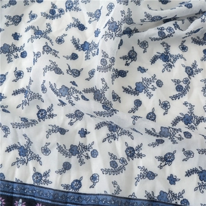 Detailed close-up of blue floral patterns on breathable cotton linen scarf fabric