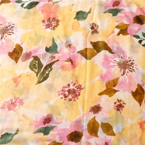 Detail of floral watercolor print on soft cotton linen scarf with vibrant yellow petals