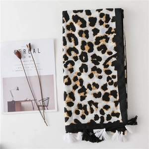 Detail shot of leopard print scarf with soft fringe tassels and cotton-linen texture