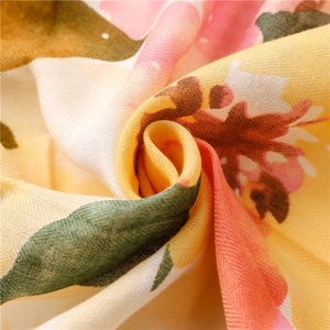 Detailed close-up of herringbone weave cotton linen scarf with colorful floral print