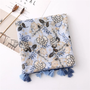 Detail of blue cotton linen floral scarf with vintage prints and soft fringe tassels