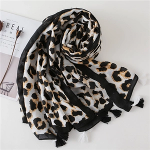 Detail of leopard print scarf with soft fringe tassels and premium woven texture