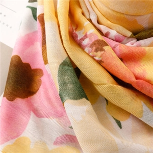 Detailed close-up of floral print cotton-linen scarf with soft twill texture and drape