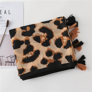 Close-up of leopard print scarf with detailed dual-color fringe on white background
