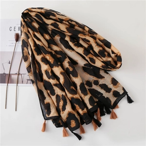 Leopard print cotton linen scarf with tassels displayed on a minimalist white background