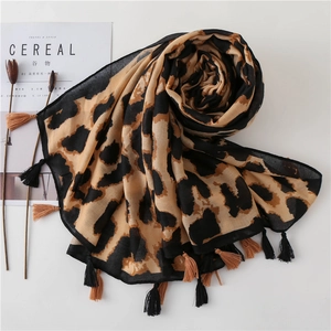 Classic leopard print scarf with black and yellow tassels on a minimalist grey background